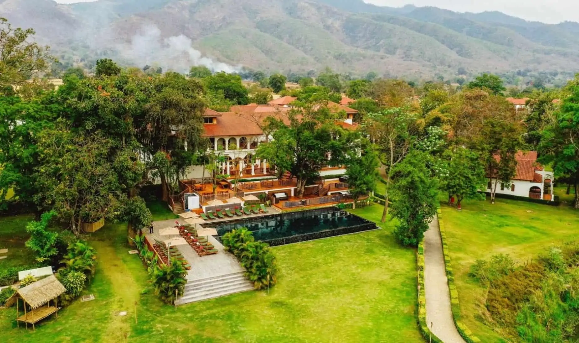 Architectural arches of Sanctum Inle Resort reflecting in the quiet lake water